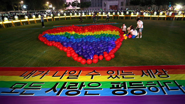 메인이미지  6 :  9일 오후 서울 서울광장에서 열린 2015 퀴어문화축제 개막식에서 관계자들이 무지개색 풍선을 이용해 하트를 만들고 있다.