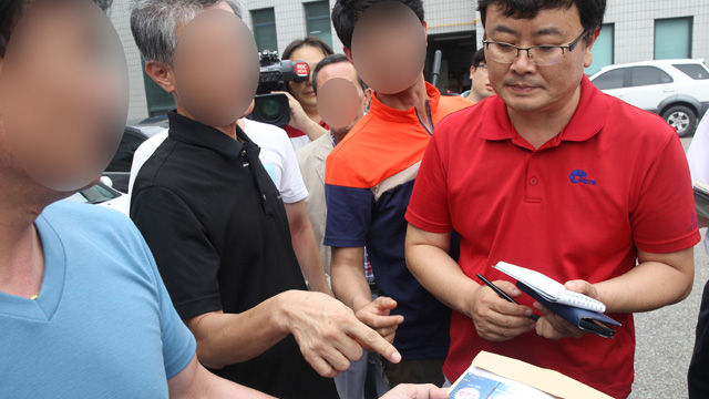메인이미지  5 : '농약 사이다' 살해사건 피의자 박모(82) 할머니의 사위가 20일 오후 대구지방법원 상주지원에서 경찰 수사에 항의하며 기자들에게 박카스병 제조번호를 설명하고 있다. (상주=연합뉴스)