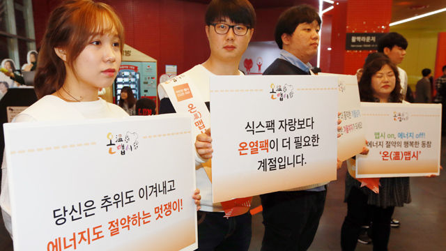 메인이미지  5 : 18일 서울 시민청에서 '따뜻한 맵시, 건강한 지구'를 주제로 열린 '온맵시 네트워크 선포식'에서 자원봉사자 등이 생활 속 에너지 절약을 위한 행동수칙 등이 담긴 손팻말을 들고 있다.