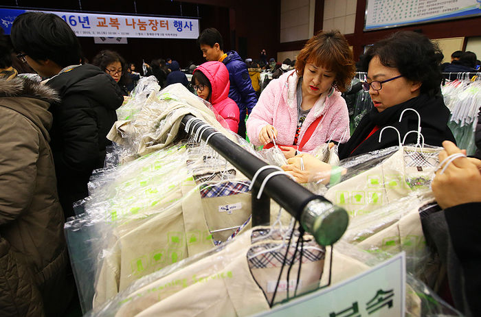 메인이미지  5 : 20일 오전 서울 동대문구청에서 열린 교복 나눔장터 행사를 찾은 주민들이 교복을 살펴보고 있다. 이번 행사에는 관내 6개 중학교와 4개 고등학교 등 총 10곳이 참여했다. 행사장을 찾은 주민들은 품목 관계 없이 장당 2천원에 5장까지 옷을 구매할 수 있다. 