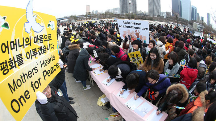 메인이미지  1 : 3.8 세계 여성의 날을 맞아 서울 여의도 시민공원에서 열린 평화 캠페인 참석자들이 세계여성평화그룹에 가입신청을 하고 있다.  이날 행사는 전 세계 132개국 여성 천만 명이 3월 8일 3시 8분(오후, 각국 현지시간)에 진행됐다.