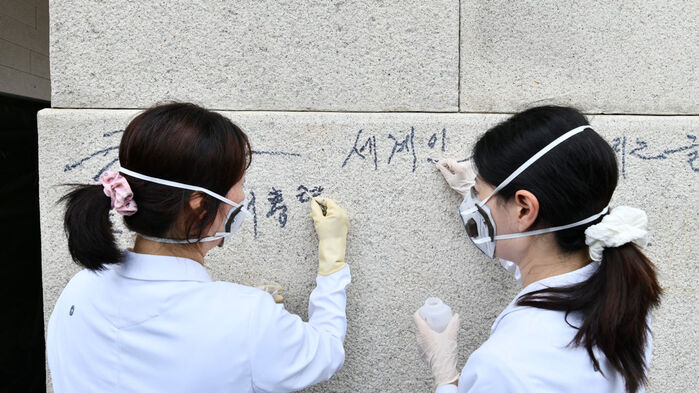 국립고궁박물관 전문가들이 낙서를 지우는 모습 (사진=국가유산청 제공, 연합뉴스)