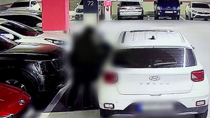 Man using someone else's car parked in a parking lot without permission