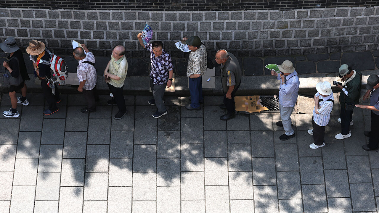 Seniors line up to receive free meals near Tapgol Park in Jongno-gu, Seoul.