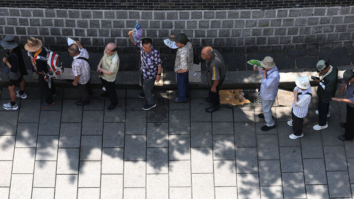 Seniors line up to receive free meals near Tapgol Park in Jongno-gu, Seoul.