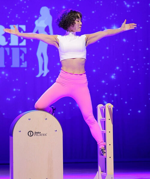 Korean-American Kelly Im demonstrating a Pilates movement