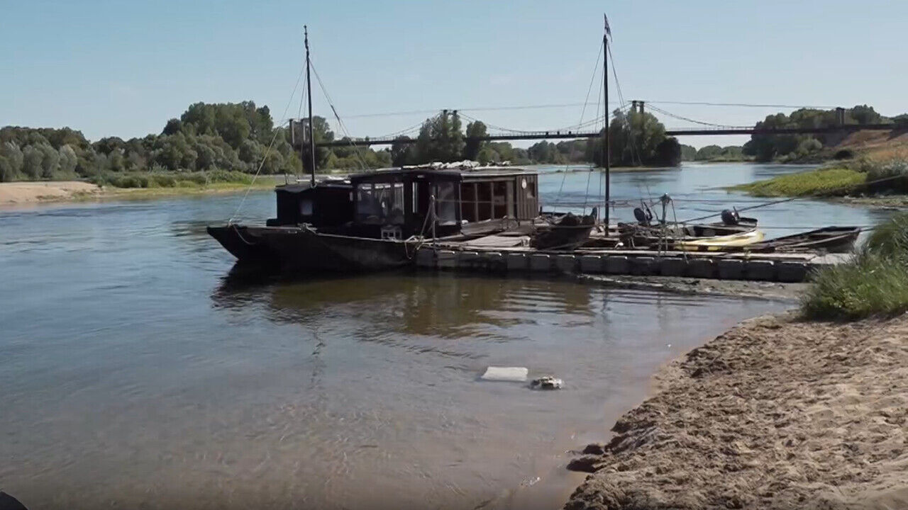 A cruise boat forced to halt operations as the Loire River bed in France is exposed