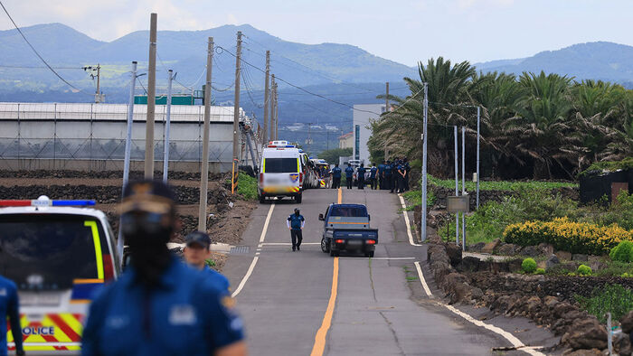 Police control the area after a body believed to be Jang Mi-ran, who went missing months ago, was found in Suwon-ri, Hanrim-eup, Jeju, on the 24th. (Photo: Yonhap News)