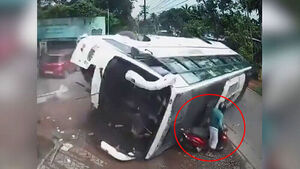 Slipping to Avoid Motorcycle, Bus Overturns... Narrow Escape