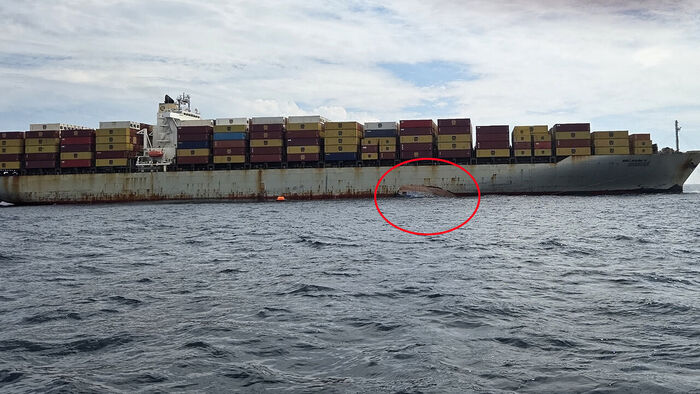 A capsized tugboat off the coast of Busan and a passing cargo ship conducting rescue operations (Photo courtesy of the Busan Coast Guard, Yonhap News)
