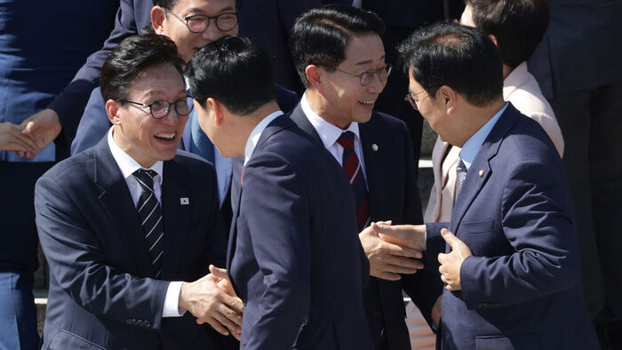 Democratic Party leader Kim Min-seok and People Power Party leader Jang Dong-hyuk greeting each other after taking a group photo
