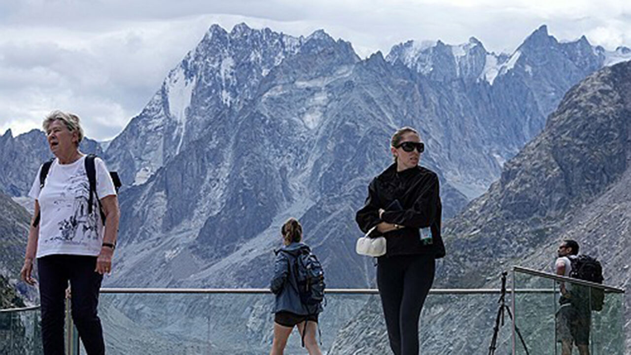Tourists looking at the peak of Mont Blanc from an observatory in Chamonix, France