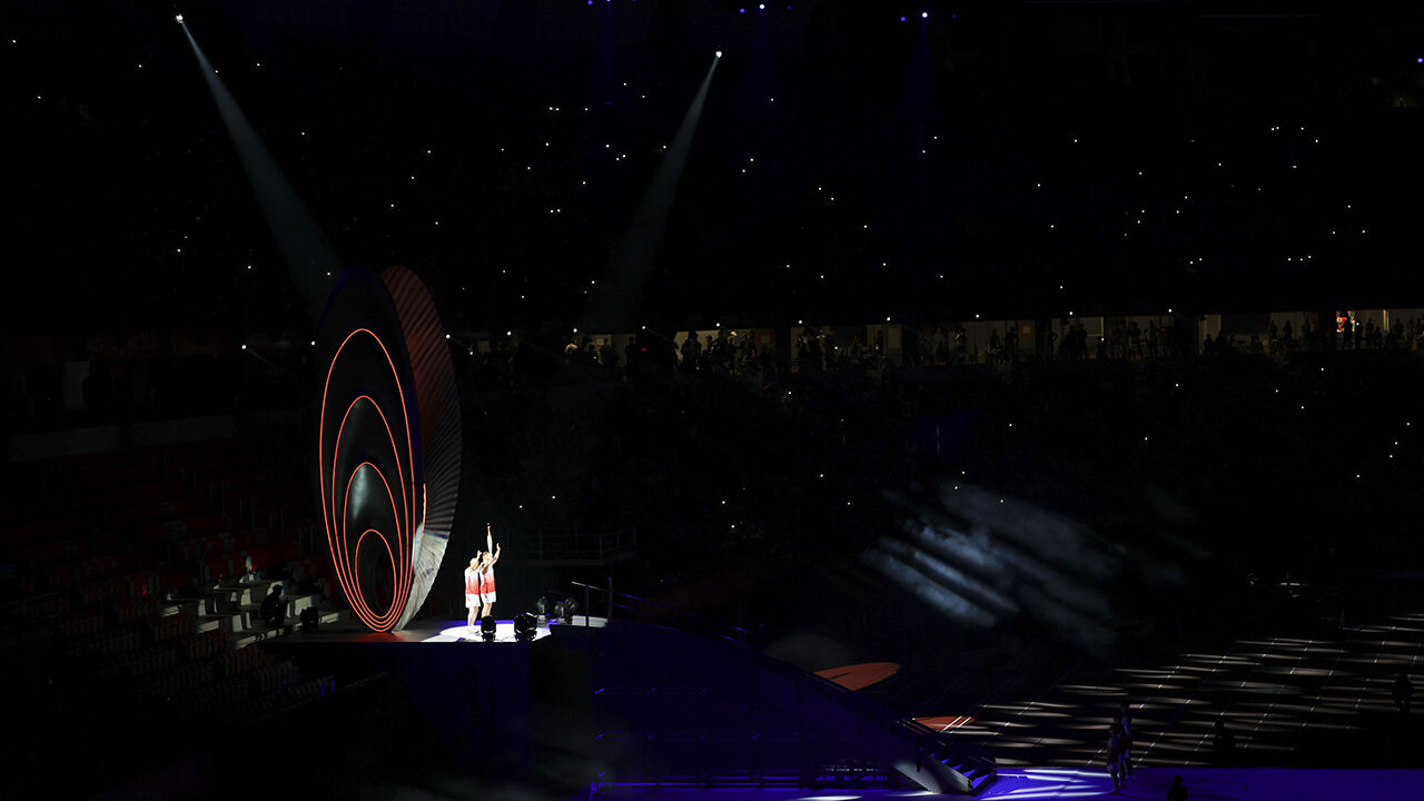 Hammer throw medalists Koji Murofushi and his father Shigenobu Murofushi carry the final torch during the opening ceremony of the 2026 Aichi-Nagoya Asian Games held at the Mizuho Park Athletics Stadium in Nagoya, Japan, on the 19th.