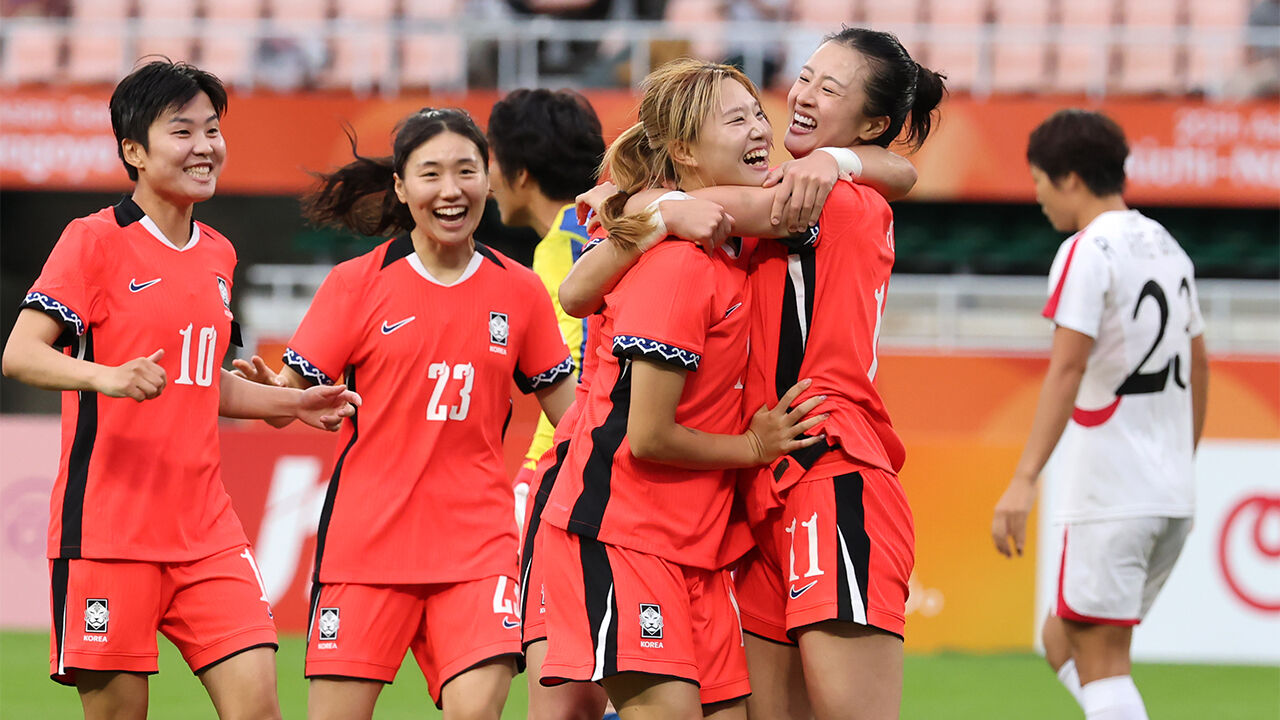South Korea's Yoon Soo-jung celebrates scoring the equalizer with her teammates during the women's football group stage match between South Korea and North Korea at the 2026 Aichi-Nagoya Asian Games at Shizuoka Stadium Ecopa in Fukuroi, Shizuoka Prefecture, Japan, on the 21st.