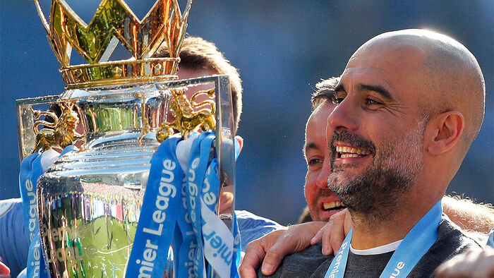 Manager Guardiola lifting the championship trophy