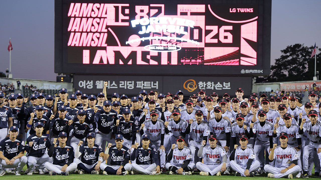 Players from the Doosan Bears and LG Twins pose for a commemorative photo in front of the baseball stadium, which is closing after this season, ahead of their KBO League game at Jamsil Baseball Stadium in Seoul on October 7.