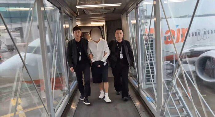 Suspect A being arrested after repatriation to South Korea