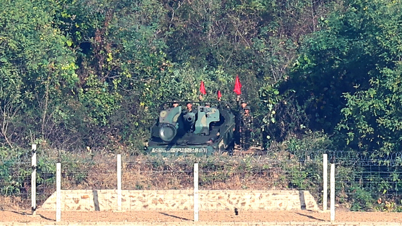 North Korean soldiers conduct self-propelled artillery drills in the coastal border area of Kaepung County, Hwanghae Province, North Korea, as seen from the Aegibong Observatory in Gimpo, Gyeonggi Province, on October 25.