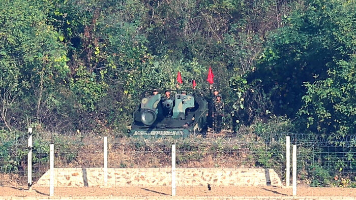 North Korean soldiers conduct self-propelled artillery drills in the coastal border area of Kaepung County, Hwanghae Province, North Korea, as seen from the Aegibong Observatory in Gimpo, Gyeonggi Province, on October 25.