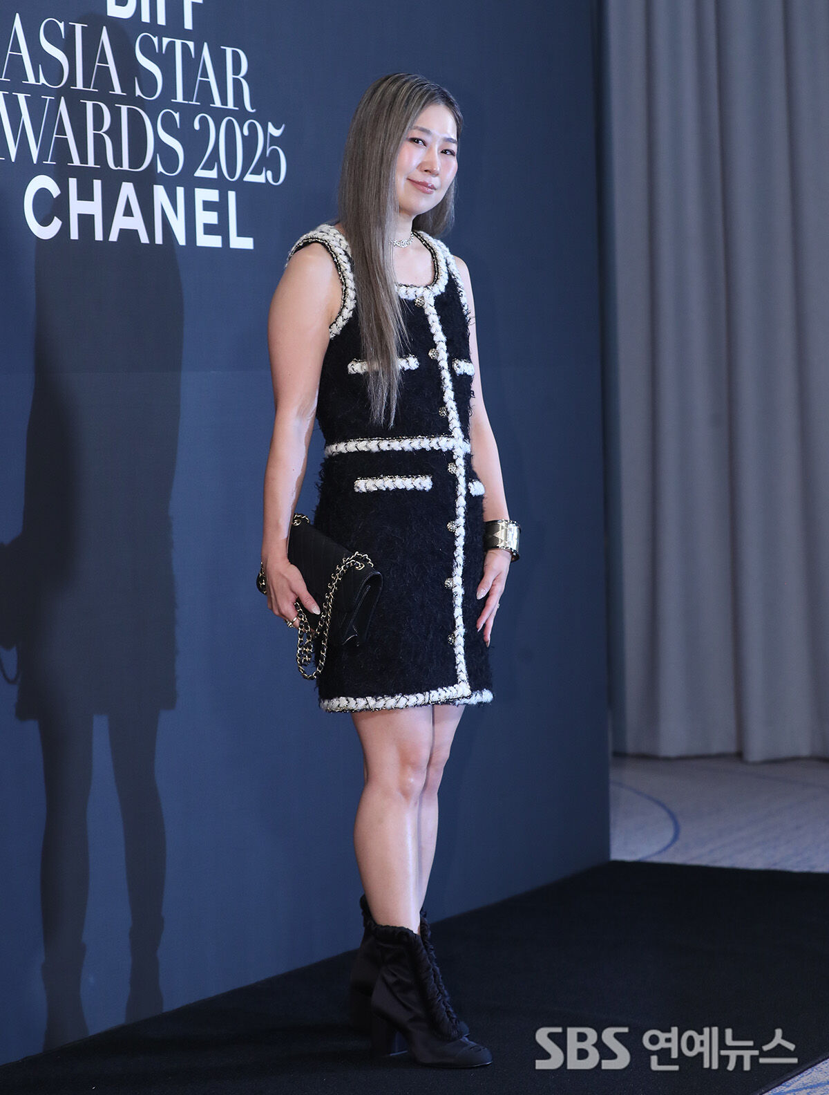 Maggie Kang poses on the photo wall at Paradise Hotel Busan