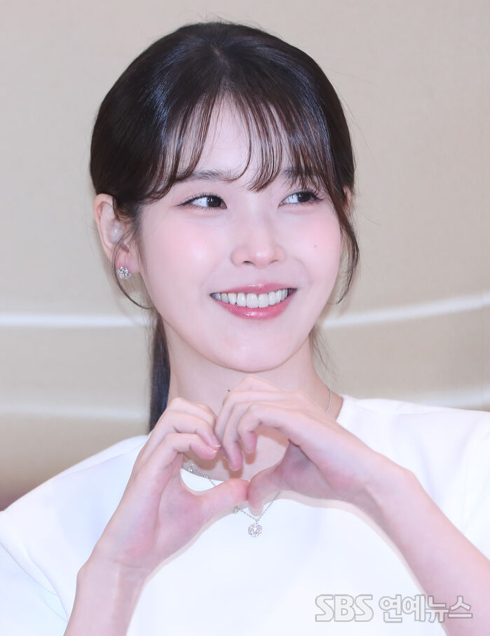 IU Flaunts Her Ever-Lovable Heart Pose