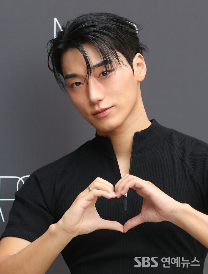 ATEEZ's San Brings Charisma to His Lovely Heart Pose