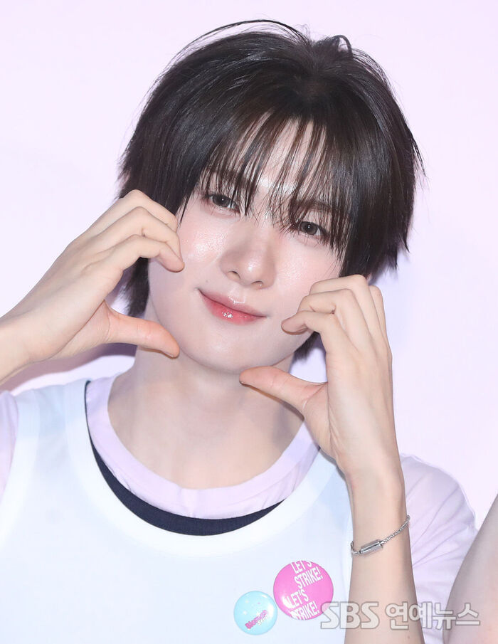 TWS's YOUNGJAE Serves Top-Tier Heart Poses at Photo Wall Event