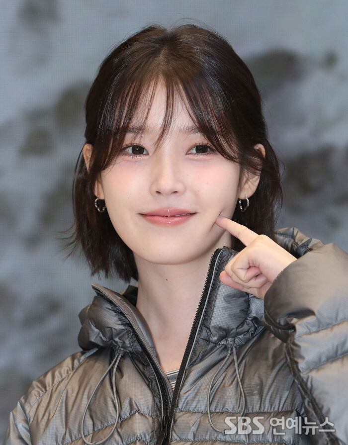 IU Charms with Sweet Cheek-Poke Smile at Sportswear Brand Event